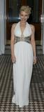Kylie Minogue steps out in a lovely long white gown on her way to her party