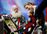 Marcia Cross and husband taking their twins to a shopping mall where they posed with Santa Claus for some family photos